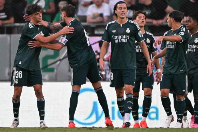 Real Madrid's Spanish defender #36 Mario Rivas (L) celebrates scoring with his team-mates during the pre-season football match between Ferencvaros and Real Madrid in Budapest, Hungary on August 8, 2026. Real Madrid on August 6, 2026 announced a new six-year deal for star forward Vinicius Junior and the signing of teenage sensation Yan Diomande in a major boost to their quest to end a two-year trophy drought. (Photo by Attila KISBENEDEK / AFP)