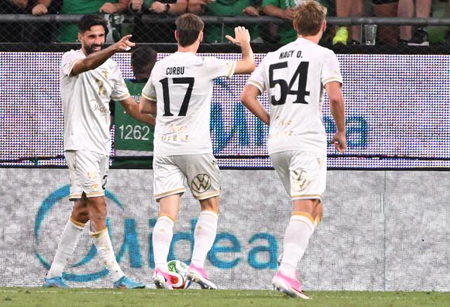 Ferencvaros' Bosnian forward #24 Kenan Kodro (L) celebrates scoring the 1-2 goal with his team-mates during the pre-season football match between Ferencvaros and Real Madrid in Budapest, Hungary on August 8, 2026. Real Madrid on August 6, 2026 announced a new six-year deal for star forward Vinicius Junior and the signing of teenage sensation Yan Diomande in a major boost to their quest to end a two-year trophy drought. (Photo by Attila KISBENEDEK / AFP)