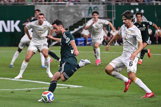 Real Madrid's Portuguese midfielder #31 Bernardo Silva (C) gets through on goal during the pre-season football match between Ferencvaros and Real Madrid in Budapest, Hungary on August 8, 2026. Real Madrid on August 6, 2026 announced a new six-year deal for star forward Vinicius Junior and the signing of teenage sensation Yan Diomande in a major boost to their quest to end a two-year trophy drought. (Photo by Attila KISBENEDEK / AFP)