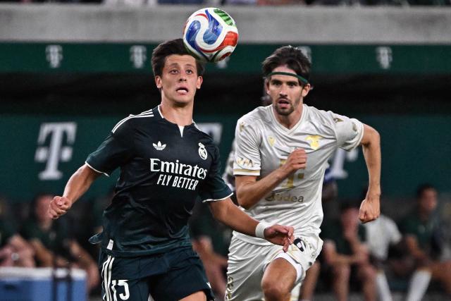 Real Madrid's Turkish midfielder #15 Arda Guler and Ferencvaros' Hungarian midfielder #06 Adam Nagy vie for the ball during the pre-season football match between Ferencvaros and Real Madrid in Budapest, Hungary on August 8, 2026. Real Madrid on August 6, 2026 announced a new six-year deal for star forward Vinicius Junior and the signing of teenage sensation Yan Diomande in a major boost to their quest to end a two-year trophy drought. (Photo by Attila KISBENEDEK / AFP)