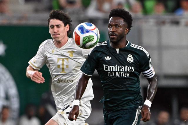 Real Madrid's Brazilian forward #07 Vinicius Junior (R) and Ferencvaros' Irish midfielder #47 Callum O'Dowda vie for the ball during the pre-season football match between Ferencvaros and Real Madrid in Budapest, Hungary on August 8, 2026. Real Madrid on August 6, 2026 announced a new six-year deal for star forward Vinicius Junior and the signing of teenage sensation Yan Diomande in a major boost to their quest to end a two-year trophy drought. (Photo by Attila KISBENEDEK / AFP)