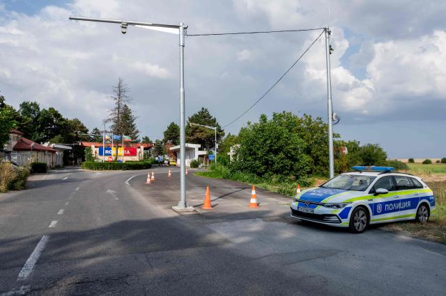 A Bulgarian police car is parked at the checkpoint near a farmland area where a drone that entered Bulgaria exploded, at the Kardam border-crossing between Bulgaria and Romania, on August 8, 2026. Ukraine on August 8 denied targeting Bulgaria after a drone exploded close to the strategic Trans-Balkan gas pipeline linking Turkey to Ukraine near the Romanian border. (Photo by Mihail IVANOV / AFP)
