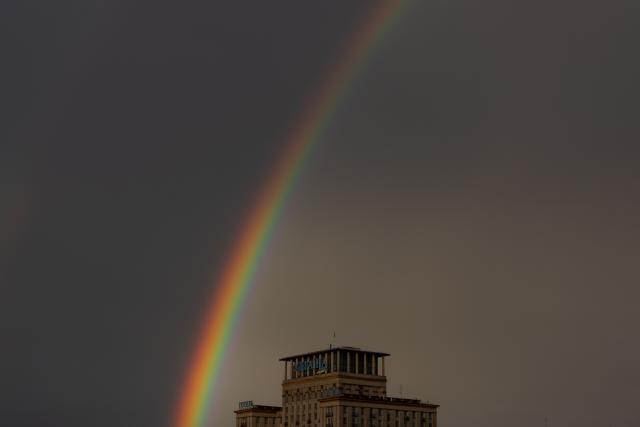 This photograph shows a double rainbow over Hotel Ukraine in downtown Kyiv, on August 8, 2026, amid the Russian invasion of Ukraine. (Photo by Roman PILIPEY / AFP)
