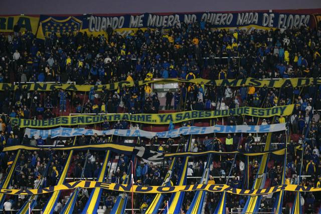 View of a banner reading "Stay strong, Messi family," which will be held up by Argentina's Boca Juniors fans to pay their respects for the death or Argentina's football star Lionel Messi's father, before an Argentine first division football match between Boca Juniors and Velez Sarsfield at the Tomas Adolfo Duco stadium in Buenos Aires, on August 8, 2026. (Photo by JUAN MABROMATA / AFP)