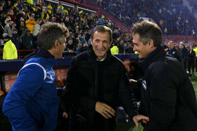Boca Juniors' head coach Rodolfo Arruabarrena (C) greets Velez Sarsfield's head coach Guillermo Barros Schelotto (R) and assistant coach Gustavo Barros Schelotto (L) ahead of the Argentine first division football match between Boca Juniors and Velez Sarsfield at the Tomas Adolfo Duco stadium in Buenos Aires on August 8, 2026. (Photo by JUAN MABROMATA / AFP)