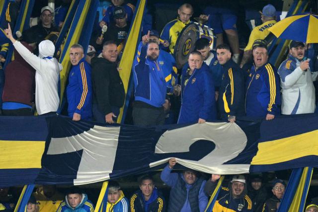 oca Juniors' "Barra Brava" leader Mauro Martin (C) points up among other fans cheering for their team during the Argentine first division football match between Boca Juniors and Velez Sarsfield at the Tomas Adolfo Duco stadium in Buenos Aires on August 8, 2026. (Photo by JUAN MABROMATA / AFP)