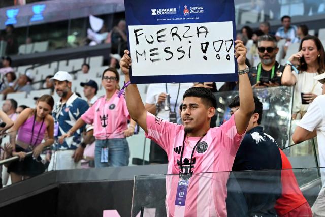 An Inter Miami fan holds a sign with a message to Argentine forward Lionel Messi ahead of the Leagues Cup 2026 group-stage football match between Inter Miami CF and Monterrey at Nu Stadium in Miami, Florida, on August 8, 2026. Jorge Messi, the father and agent of Lionel Messi, has died aged 68 in Rosario, Argentina, the eight-time Ballon d'Or winner's childhood club Newell's Old Boys announced on August 8. (Photo by CHANDAN KHANNA / AFP)