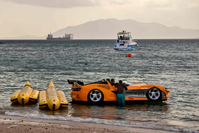 A sports car-shaped boat is available for rent on a beach on Taboga Island, off Panama City, on August 8, 2026. (Photo by MARTIN BERNETTI / AFP)