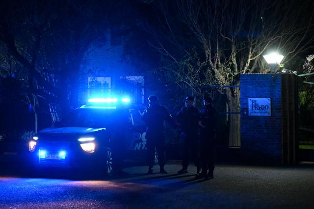 Argentine police officers stand guard at the entrance to El Prado cemetery on the outskirts of Rosario, Santa Fe province, Argentina, on August 8, 2026. Jorge Messi, the father and agent of Lionel Messi, has died aged 68, the eight-time Ballon d'Or winner's childhood club Newell's Old Boys announced on August 8, 2026. (Photo by Luis ROBAYO / AFP)