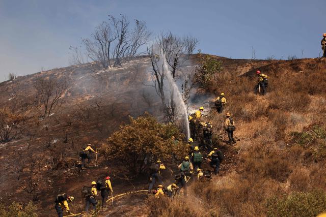 Los Angeles firefighters battle the Walnut Fire in the Wildwood Canyon shortly after breaking out on August 8, 2026 in Burbank, California. The blaze that started on Saturday afternoon forced evacuation orders and warnings to nearby residents. (Photo by David Swanson / AFP)