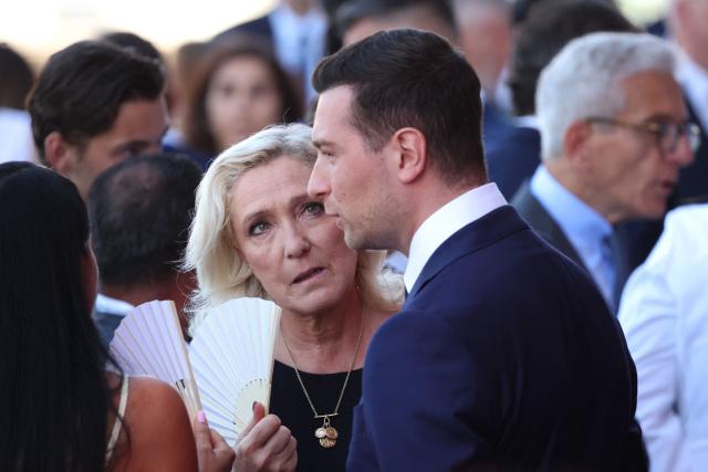 (FILES) President of Rassemblement National parliamentary group Marine Le Pen (L) looks on next to President of French far-right party Rassemblement National (RN) Jordan Bardella prior to a ceremony marking the 10th anniversary of an attack that killed 86 people and injured more than 400 in Nice, on the French riviera city of Nice on July 14, 2026. Behind the scenes, the French far-right party Rassemblement National (RN) candidate for the presidential election relies above all on her family and her inner circle: more than just a team, its a clan. (Photo by Valery HACHE / AFP)
