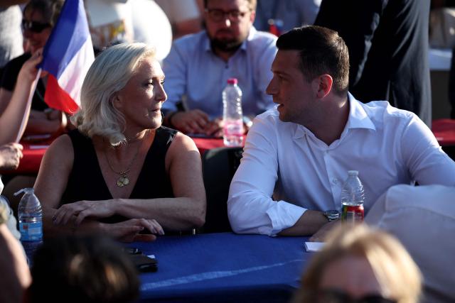 (FILES) French far-right party Rassemblement National (RN) president Jordan Bardella (R) and President of Rassemblement National parliamentary group Marine Le Pen (L) attend a RN party event "La fete champetre" in Lievin, northern France on July 4, 2026. Behind the scenes, the French far-right party Rassemblement National (RN) candidate for the presidential election relies above all on her family and her inner circle: more than just a team, it’s a clan. (Photo by SIMON WOHLFAHRT / AFP)