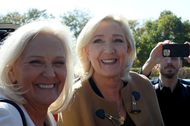 (FILES) President of French far-right party Rassemblement National parliamentary group Marine Le Pen (R) and Rassemblement National Departmental (Sarthe) representative Marie-Caroline Le Pen (L) arrive at the Firefighters' conference, at the Exhibitions Centre, in Le Mans, western France, on October 10, 2025. Behind the scenes, the French far-right party Rassemblement National (RN) candidate for the presidential election relies above all on her family and her inner circle: more than just a team, its a clan. (Photo by JEAN-FRANCOIS MONIER / AFP)