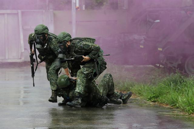 Taiwanese soldiers conduct a chemical contamination rescue drill as part of the annual Han Kuang military exercise in Hualien on August 9, 2026. (Photo by Chiang Ying-ying / POOL / AFP)