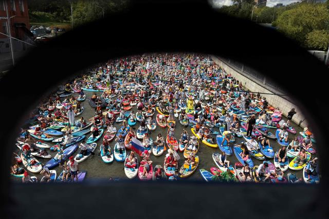 Participants attend the Yauzafest SUP stand-up paddle boarding festival on the Yauza river in Moscow on August 9, 2026. (Photo by Igor IVANKO / AFP)