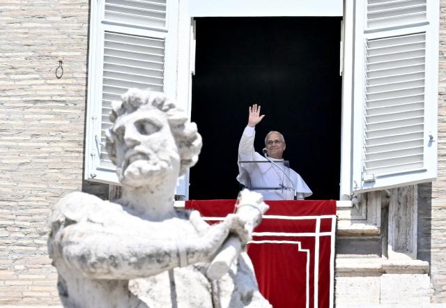 Pope Leo XIV waves during his Angelus prayer from a balcony overlooking St. Peter's Square at the Vatican, on August 9, 2026. (Photo by Filippo MONTEFORTE / AFP)