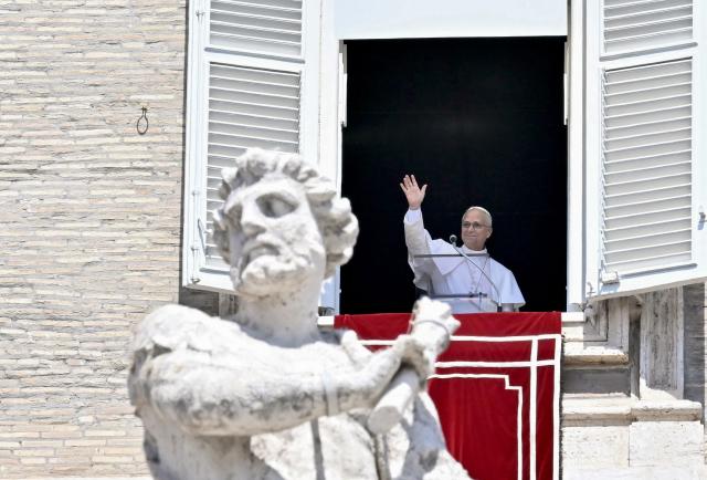 Pope Leo XIV waves to pilgrims gathered in St. Peter's Square at The Vatican on August 9, 2026, after delivering The Angelus Prayer. (Photo by Filippo MONTEFORTE / AFP)