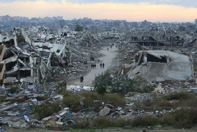 (FILES) A general view of destroyed houses in Nuseirat camp in the central Gaza Strip on December 19, 2025. Israel's prime minister on August 9, 2026, rejected a Gaza plan hailed by the US president, vowing no military pullout until Hamas is "genuinely" disarmed. "Israel rejects the 15-point document. The IDF will not carry out any withdrawal until Hamas is genuinely disarmed and will continue to thwart threats against our forces and our citizens," the Israeli Prime Minister said at a cabinet meeting, referring to the Israeli military. (Photo by Eyad Baba / AFP)