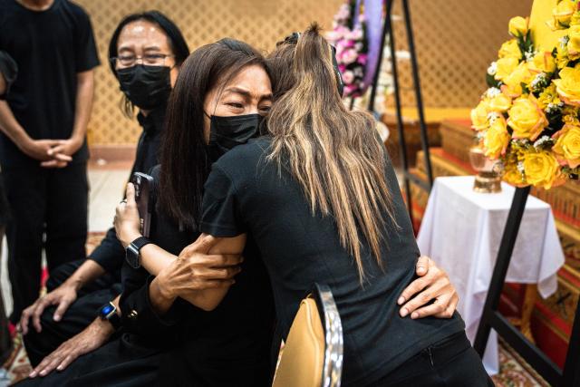 Family members of 12-year-old school shooting victim Naphat Chaima react during her funeral at the Wat Lat Pla Duk Buddhist temple in Nonthaburi province, north of Thailand's capital Bangkok, on August 9, 2026. A teenage assailant shot his grandparents, using his grandfather's handgun, at their home north of Bangkok on August 7 before going on a killing spree at his secondary school and ultimately turning the gun on himself, according to authorities. (Photo by Chanakarn LAOSARAKHAM / AFP)