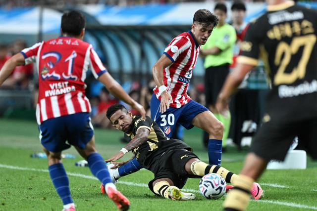 Manchester City’s Savinho (bottom C) competes for the ball with Atletico Madrid’s Dani Martinez (top C) during their pre-season exhibition friendly football match at Seoul World Cup Stadium in Seoul on August 9, 2026. (Photo by GREG BAKER / AFP)