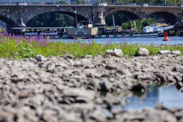 A passengers ship is seen by the bridge on Elbe in Dresden, eastern Germany, on August 9, 2026, with hot and dry weather conditions keeping very low the water level of the river. (Photo by Jens SCHLÜTER / AFP)