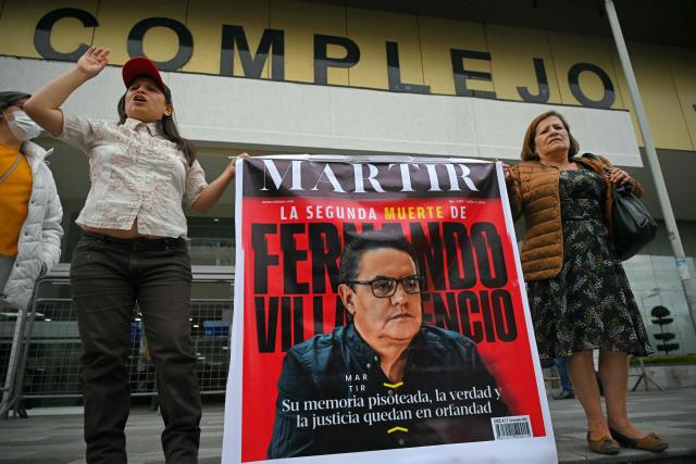 (FILES) Supporters of Fernando Villavicencio shout slogans as they await the sentencing at the trial against the five alleged murderers of former Ecuadorian presidential candidate Fernando Villavicencio at the Judicial Complex in Quito on July 12, 2024. Ecuador's Prosecutor's Office formally charged seven people on August 8, 2026 on suspicion of being the masterminds behind an assassination plot against a prominent presidential candidate in 2023. Fernando Villavicencio, a legislator known for his anti-corruption investigations, was polling in second place when he was shot and killed at a campaign event in Quito 11 days before the 2023 presidential election. (Photo by Rodrigo BUENDIA / AFP)