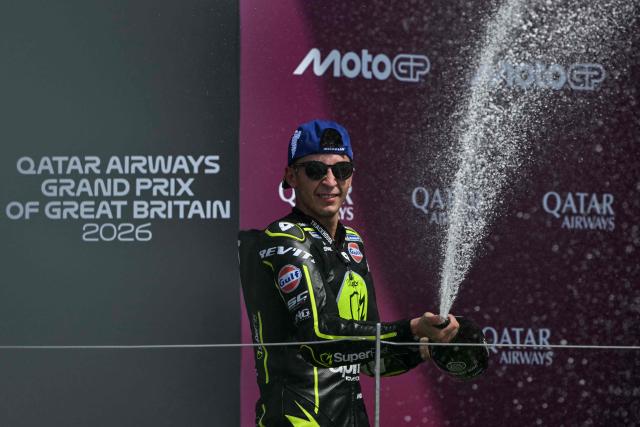 Winner Trackhouse MotoGP's Spanish rider Raul Fernandez sprays champagne to celebrate his victory on the podium at the end of the MotoGP British Grand Prix at Silverstone circuit, central England on August 9, 2026. (Photo by Glyn KIRK / AFP)