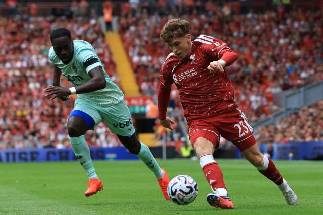 Liverpool's Spanish midfielder #23 Víctor Muñoz (R) runs away from Monaco's Dutch defender #04 Jordan Teze (L) during the pre-season friendly football match between Liverpool and Monaco at Anfield in Liverpool, north west England on August 9, 2026. (Photo by Darren Staples / AFP)