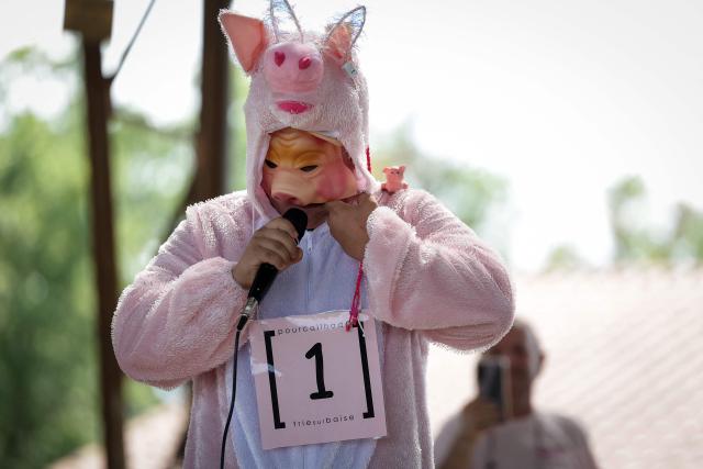 A participant in the French pig-squealing championship performs on stage at the 43rd edition of the Pig Festival, in Trie-sur-Baïse, south-western France, on August 9, 2026. (Photo by Valentine CHAPUIS / AFP)