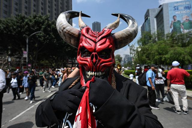 A member of an indigenous community takes part in the "Mega Calenda" parade, which commemorates the International Day of the World's Indigenous Peoples, in Mexico City on August 9, 2026. (Photo by Yuri CORTEZ / AFP)