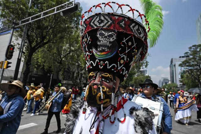 A member of an indigenous community takes part in the "Mega Calenda" parade, which commemorates the International Day of the World's Indigenous Peoples, in Mexico City on August 9, 2026. (Photo by Yuri CORTEZ / AFP)
