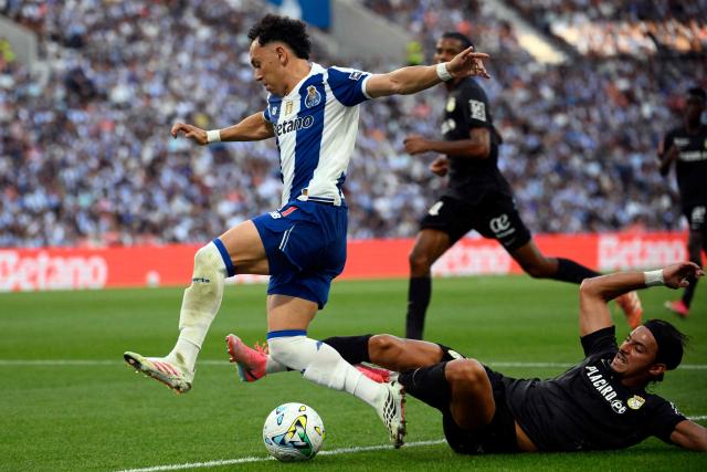 FC Porto's Brazilian forward #11 Pepe is tackled by FC Alverca's Moroccan forward #02 Nabil Touaizi during the Portuguese League football match between FC Porto and FC Alverca at Dragao stadium in Porto on August 8, 2026. (Photo by Miguel RIOPA / AFP)