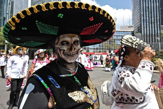 Members of indigenous communities from different Mexican states wear traditional costumes while participating in the "Mega Calenda" parade, which commemorates the International Day of the World's Indigenous Peoples, in Mexico City on August 9, 2026. (Photo by Yuri CORTEZ / AFP)