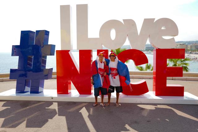 Fans pose in front of the logo '#ILoveNice' during the 9th and final stage of the fifth edition of the Women's Tour de France cycling race, 99.2 km from Nice to Nice, southeastern France on August 9, 2026. (Photo by Valery HACHE / AFP)