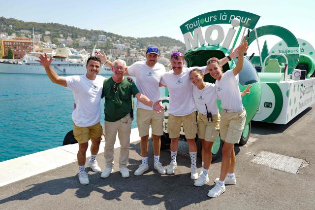 Members of the 'Caravane du Tour' pose prior to the 9th and final stage of the fifth edition of the Women's Tour de France cycling race, 99.2 km from Nice to Nice, southeastern France on August 9, 2026. (Photo by Valery HACHE / AFP)