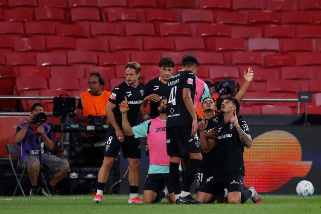 Academico de Viseu's Portuguese defender #44 Ruben Pereira (R) celebrates scoring his team's first goal during the Portuguese League football match between SL Benfica and Academico de Viseu FC at Estadio da Luz in Lisbon on August 9, 2026. (Photo by FILIPE AMORIM / AFP)