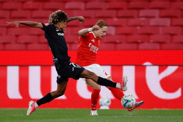 Academico de Viseu's Portuguese defender #75 Ricardo Ribeiro Vieira "Robinho" (L) tackles Benfica's Norwegian forward #21 Andreas Schjelderup during the Portuguese League football match between SL Benfica and Academico de Viseu FC at Estadio da Luz in Lisbon on August 9, 2026. (Photo by FILIPE AMORIM / AFP)