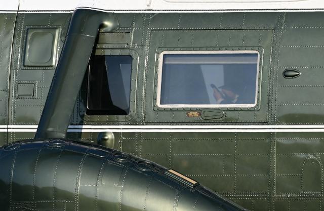 US President Donald Trump uses his phone aboard Marine One after landing on the Ellipse near the White House in Washington, DC, on August 9, 2026. President Trump is returning to the White House after spending the weekend at his National Golf Club in Bedminster, New Jersey. (Photo by Brendan SMIALOWSKI / AFP)