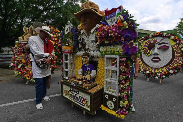 Farmers carrying traditional flower arrangements known as "silletas" prepare for the Silleteros Parade during the Flower Festival in Medellin, Antioquia department, Colombia, on August 9, 2026. (Photo by Jaime SALDARRIAGA / AFP)