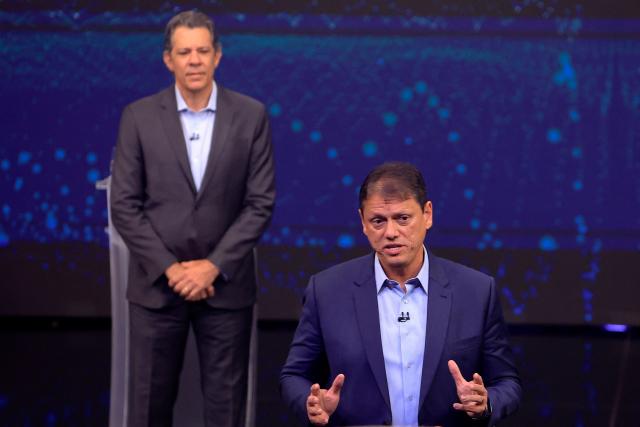 Brazilian Governor of Sao Paulo and reelection candidate Tarcisio de Freitas (R) speaks in front of former Finance Minister and gubernatorial candidate Fernando Haddad during a televised debate ahead of the 2026 Sao Paulo state elections at Band TV studios in Sao Paulo, Brazil, on August 9, 2026. (Photo by Miguel SCHINCARIOL / AFP)