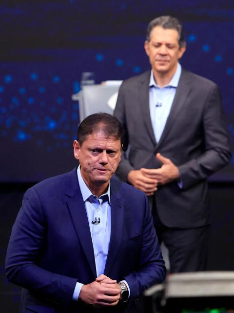 Brazilian Governor of Sao Paulo and reelection candidate Tarcisio de Freitas (L) speaks in front of former Finance Minister and gubernatorial candidate Fernando Haddad during a televised debate ahead of the 2026 Sao Paulo state elections at Band TV studios in Sao Paulo, Brazil, on August 9, 2026. (Photo by Miguel SCHINCARIOL / AFP)