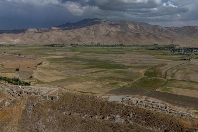 EDITORS NOTE: Graphic content / This aerial photograph, taken on July 22, 2026 in Van shows the remains of the fortress of Cavustepe in Van, in eastern Turkey. Mehmet Kusman, 86, has dedicated his life to the Cavustepe Fortress in eastern Turkey and to studying the Urartian language, which borrows its cuneiform alphabet from Assyrian to honor the gods and rulers of the lost kingdom. (Photo by Ozan KOSE / AFP)