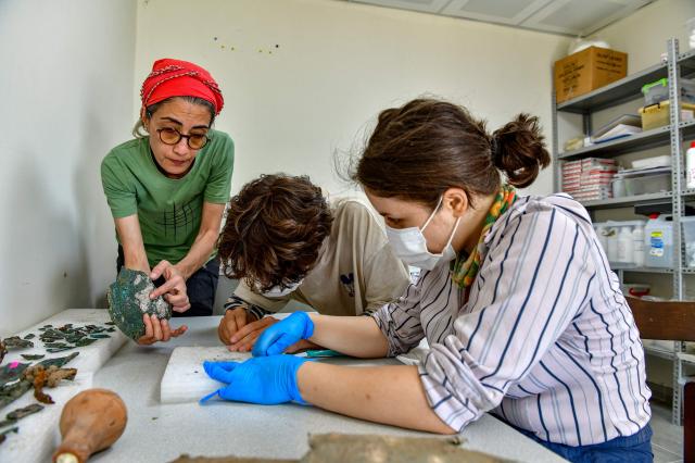 EDITORS NOTE: Graphic content / Archaeologists works on inscriptions at the fortress of Ayanis near Van, in eastern Turkey, on August 4, 2026. Although it emerged later than the great Mesopotamian kingdoms of Assyria, Sumer, and Babylon, Urartu succeeded in uniting the tribal communities of the Autoru Mountains into a centralized state, building fortresses, provincial capitals, irrigation networks, and vast storage facilities to support an agricultural economy. (Photo by Ali IHSAN OZTURK / AFP)