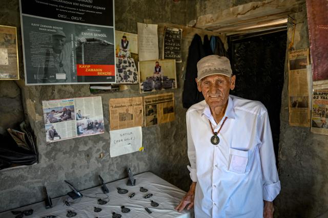 Mehmet Kusman, aged 86, who speaks Urartian language, poses at his workshop at the fortress of Cavustepe near Van, in eastern Turkey, on July 22, 2026. Mehmet Kusman, 86, has dedicated his life to the Cavustepe Fortress in eastern Turkey and to studying the Urartian language, which borrows its cuneiform alphabet from Assyrian to honor the gods and rulers of the lost kingdom. (Photo by Ozan KOSE / AFP)