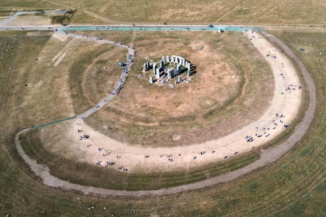 (FILES) This aerial image shows the scorched grass surrounding the area at Stonehenge near Amesbury, Wiltshire in southern England on July 28, 2026. Climate change has intensified a drought across Europe this summer, with extreme heat driving the exceptionally dry conditions, according to experts. (Photo by JUSTIN TALLIS / AFP)