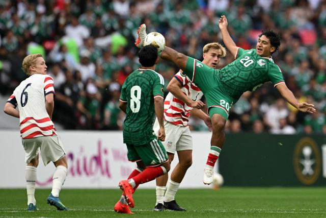 Mexico's defender #20 Diego Ramirez kicks the ball past US defender #05 Braden Dunham during the Concacaf U-20 Championship final football match between United States and Mexico at the Banorte Stadium in Mexico City on August 9, 2026. (Photo by Yuri CORTEZ / AFP)