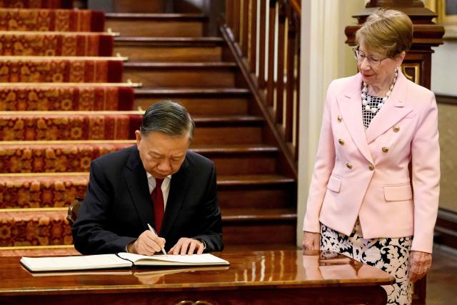 Vietnam's President To Lam (L) signs the visitors' book next to New South Wales Governor Margaret Beazley at Government House in Sydney on August 10, 2026. (Photo by BIANCA DE MARCHI / POOL / AFP)