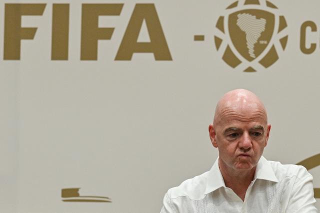 (FILES) FIFA President Gianni Infantino gestures during his visit to the new Concentration Hotel of the Colombian Football Federation in Barranquilla, Colombia, on February 24, 2026. FIFA president Gianni Infantino came under renewed fire on August 10, 2026 as a joint letter from three confederations -- UEFA, CONCACAF and AFC -- declared football "belongs to no individual". (Photo by David SALAZAR / AFP)