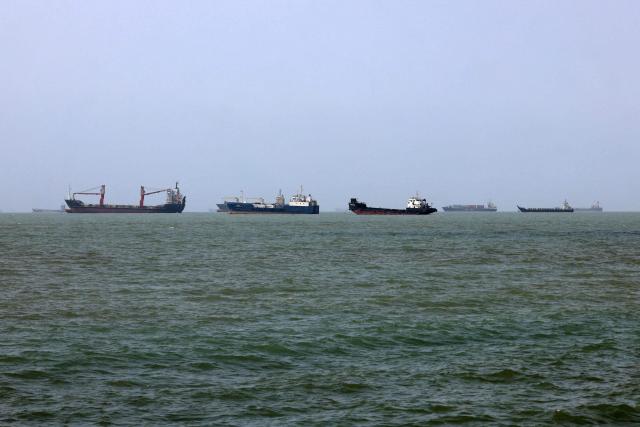 Vessels transit the Strait of Hormuz off Bandar Abbas in southern Iran on August 10, 2026. The US President signalled on August 9 that he was prepared to let economic pressure mount against Iran, apparently backing away from more military strikes after Tehran issued a list of demands for opening the Strait of Hormuz. His remarks came after Iran issued over the weekend a list of conditions to reopen the Strait of Hormuz, which has remained largely closed since the start of the Middle East war in late February. (Photo by ATTA KENARE / AFP) / 