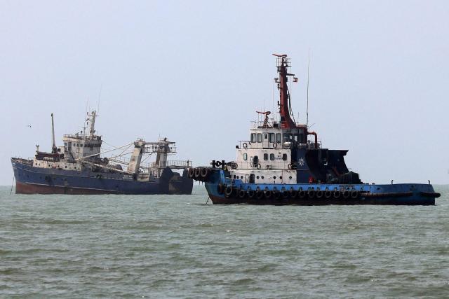 Vessels transit the Strait of Hormuz off Bandar Abbas in southern Iran on August 10, 2026. The US President signalled on August 9 that he was prepared to let economic pressure mount against Iran, apparently backing away from more military strikes after Tehran issued a list of demands for opening the Strait of Hormuz. His remarks came after Iran issued over the weekend a list of conditions to reopen the Strait of Hormuz, which has remained largely closed since the start of the Middle East war in late February. (Photo by ATTA KENARE / AFP) / 